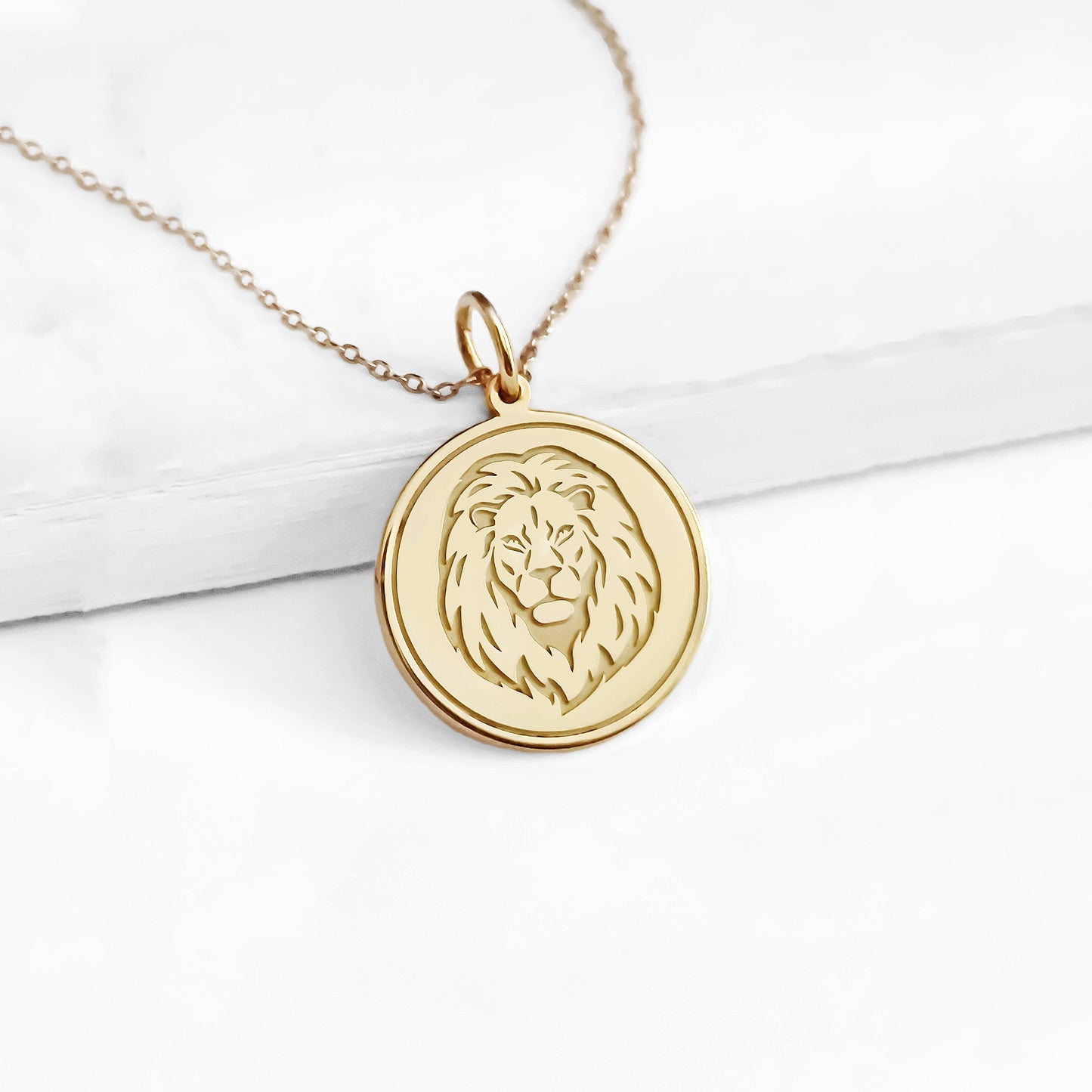 14K yellow gold disc pendant necklace engraved with a lion head and a circle frame around it