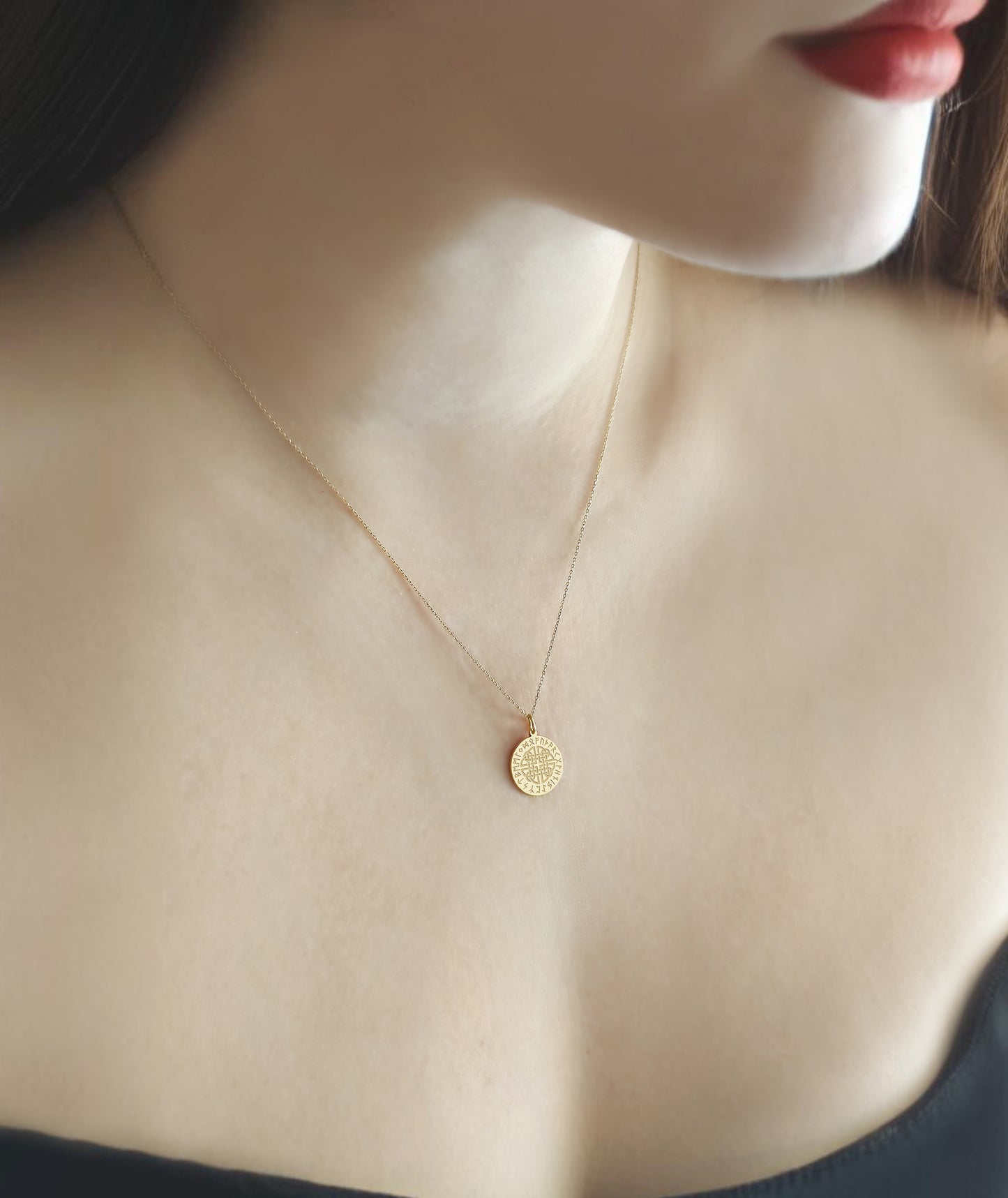 female wearing gold dara knot pendant necklace