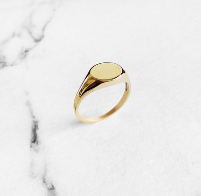 front view of a solid yellow gold dainty oval signet ring