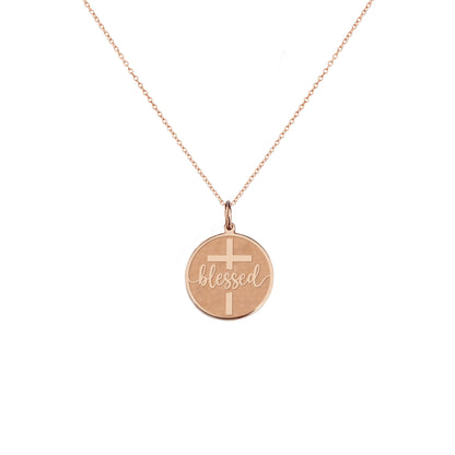 solid rose gold necklace with a disc pendant engraved with the word blessed and a cross 