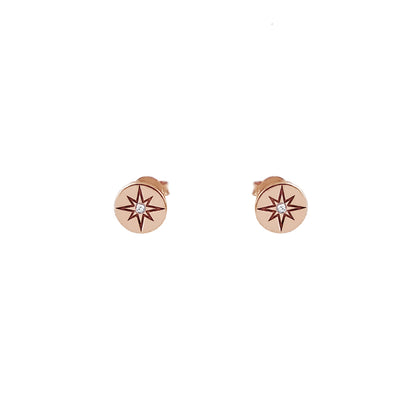 pair of solid rose gold north star disc stud earrings set with a tiny diamond in the center