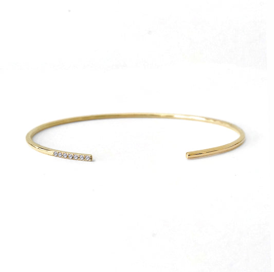 solid yellow gold thin open cuff bracelet with seven diamonds set on one side