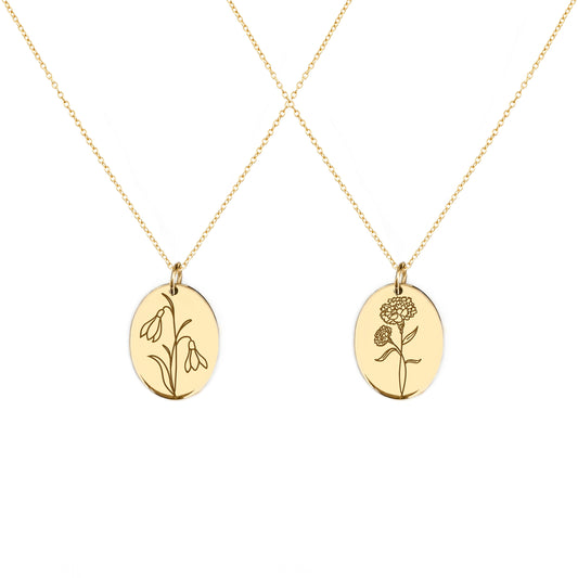 two solid yellow gold oval pendant necklaces engraved with the birth flowers of January Snowdrop and Carnation